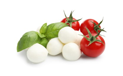 Photo of Tasty mozzarella cheese balls, tomatoes and basil isolated on white