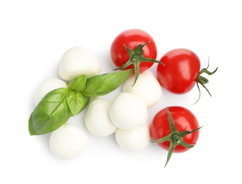 Photo of Tasty mozzarella cheese balls, tomatoes and basil isolated on white, top view