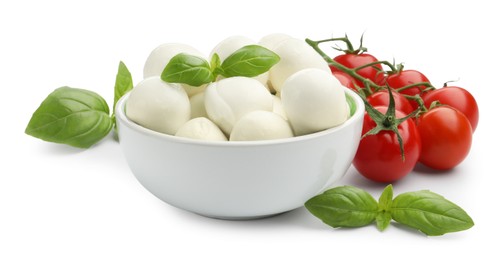 Photo of Tasty mozzarella cheese balls, tomatoes and basil isolated on white