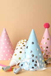 Photo of Party hats and festive decor on beige background. Space for text