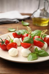 Photo of Appetizers with mozzarella, tomatoes and basil on wooden table, closeup