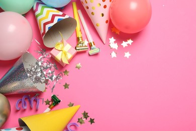 Photo of Party hats and festive decor on pink background, flat lay. Space for text