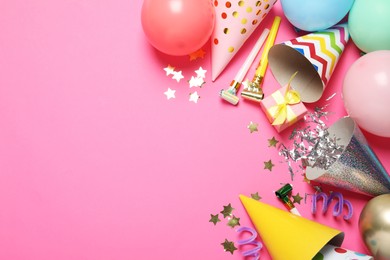 Photo of Party hats and festive decor on pink background, flat lay. Space for text