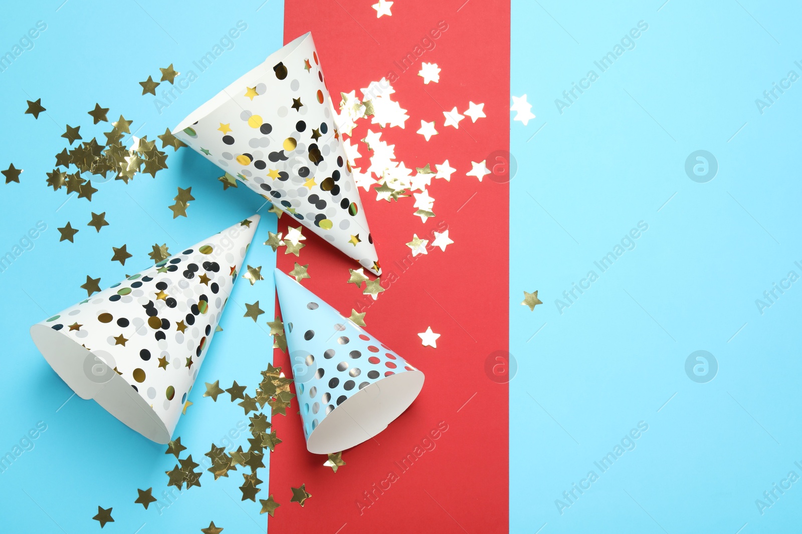 Party hats and festive decor on color background, flat lay. Space for text Photo of Party hats and festive decor on color background, flat lay. Space for text