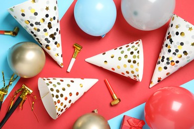 Photo of Party hats and festive decor on color background, flat lay