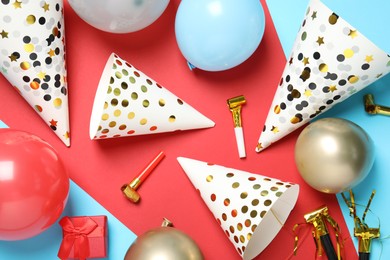 Photo of Party hats and festive decor on color background, flat lay