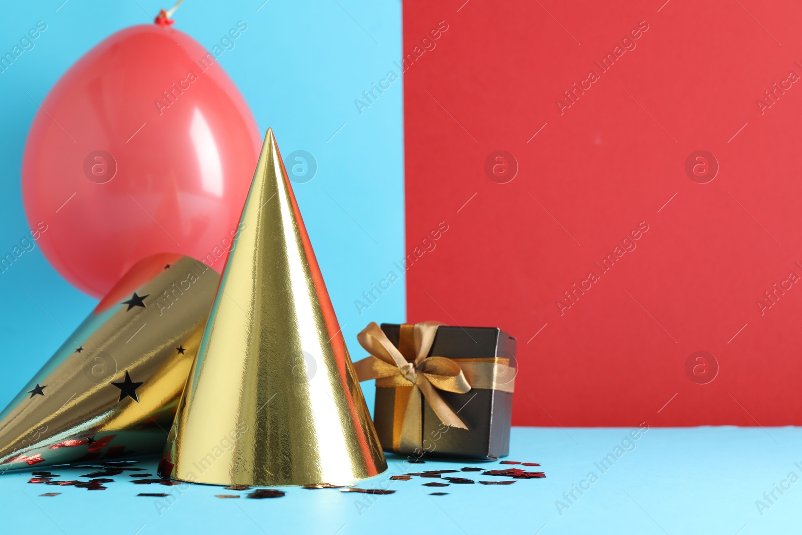 Party hats and festive decor on color background. Space for text Photo of Party hats and festive decor on color background. Space for text