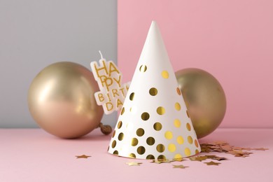 Photo of Party hat and festive decor on color background