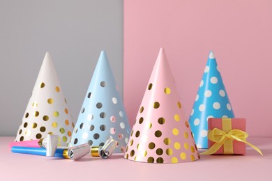 Photo of Party hats and festive decor on color background