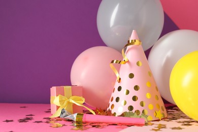 Photo of Party hat and festive decor on color background. Space for text