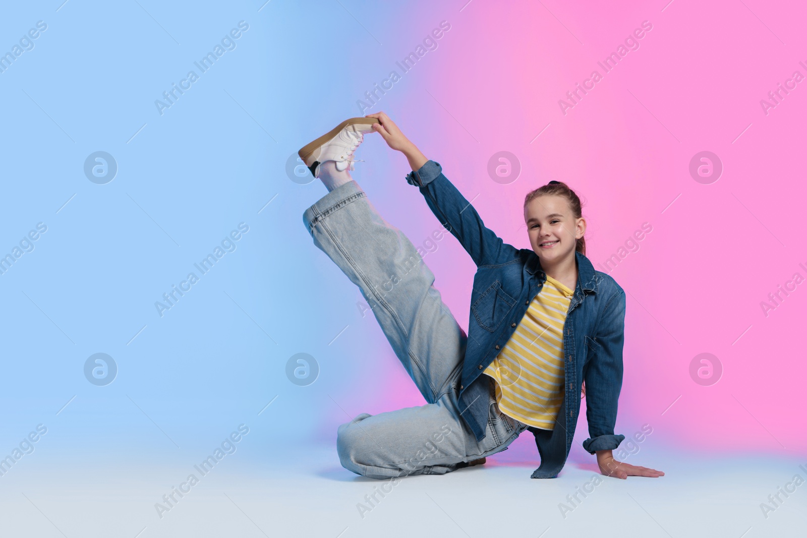 Girl in stylish clothes dancing on color background, space for text Photo of Girl in stylish clothes dancing on color background, space for text