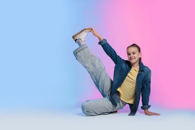 Photo of Girl in stylish clothes dancing on color background, space for text