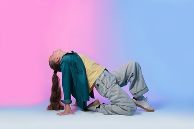Photo of Girl in stylish clothes dancing on color background