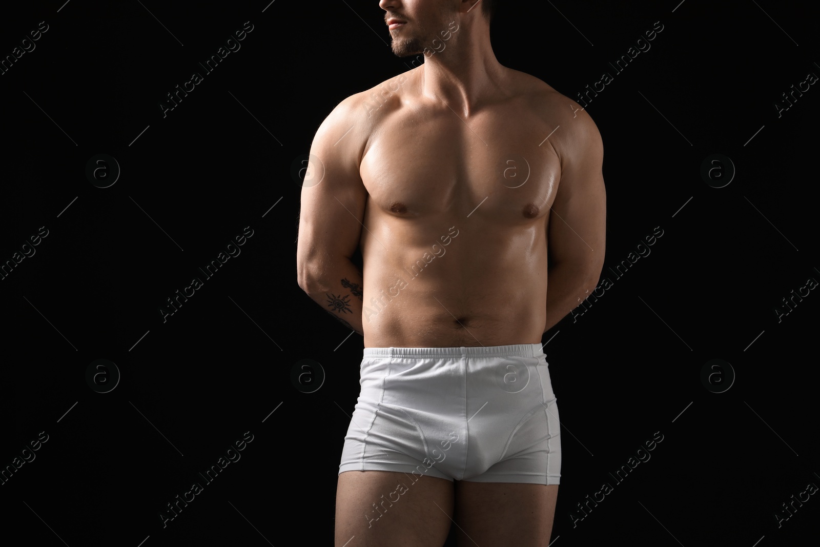 Young man in stylish white underwear on black background, closeup Photo of Young man in stylish white underwear on black background, closeup