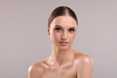 Photo of Portrait of beautiful young woman on gray background