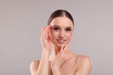 Photo of Portrait of beautiful young woman on gray background