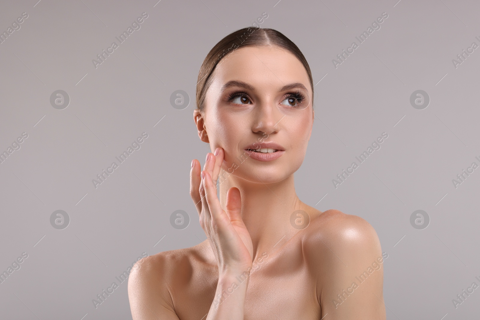 Portrait of beautiful young woman on gray background Photo of Portrait of beautiful young woman on gray background
