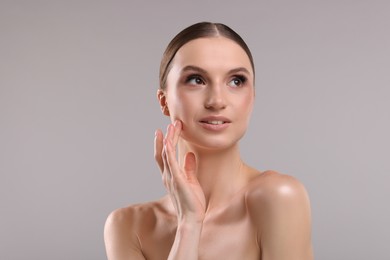 Photo of Portrait of beautiful young woman on gray background