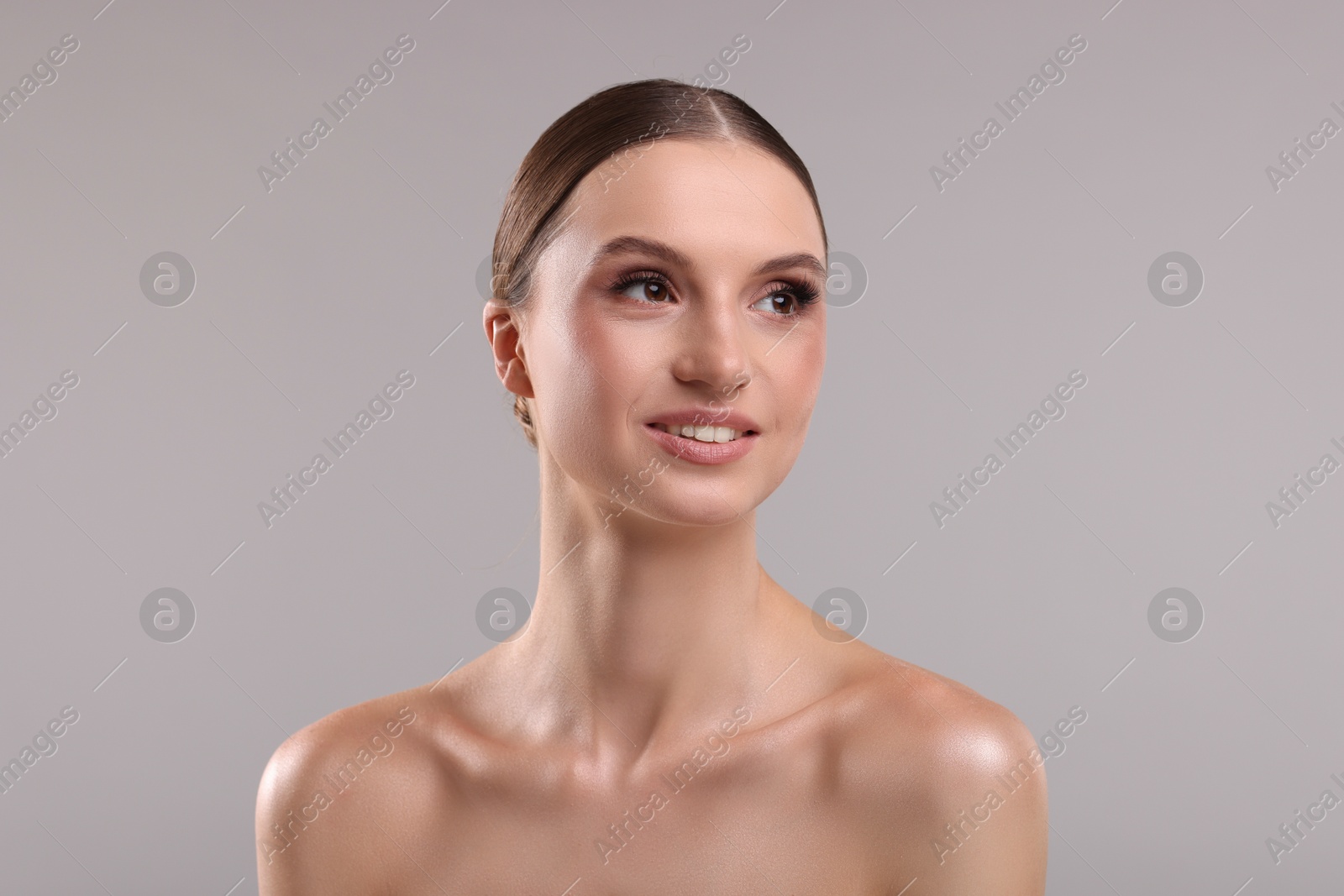 Portrait of beautiful young woman on gray background Photo of Portrait of beautiful young woman on gray background