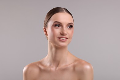 Photo of Portrait of beautiful young woman on gray background