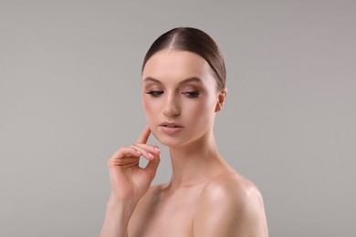 Photo of Portrait of beautiful young woman on gray background