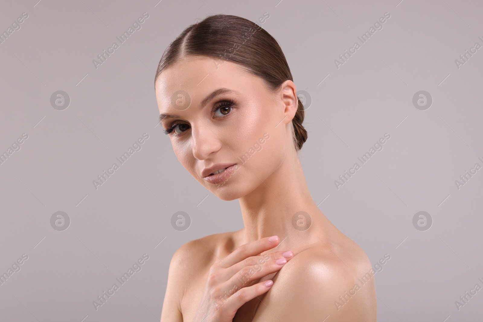Portrait of beautiful young woman on gray background Photo of Portrait of beautiful young woman on gray background