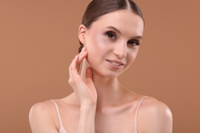 Photo of Portrait of beautiful young woman on beige background