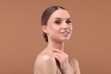 Photo of Portrait of beautiful young woman on beige background