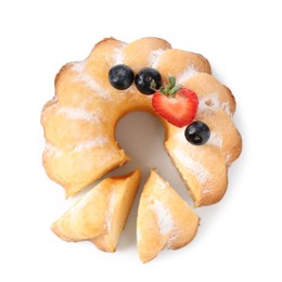 Photo of Tasty bundt cake with powdered sugar and berries isolated on white, top view