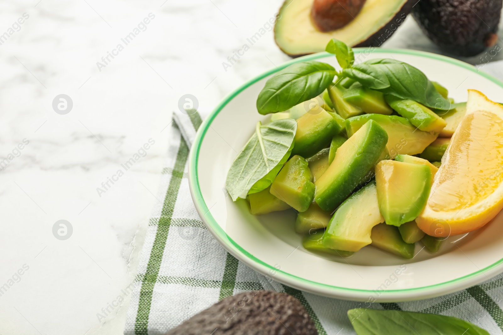 Tasty ripe green avocados, basil and lemon on white marble table, closeup. Space for text Photo of Tasty ripe green avocados, basil and lemon on white marble table, closeup. Space for text