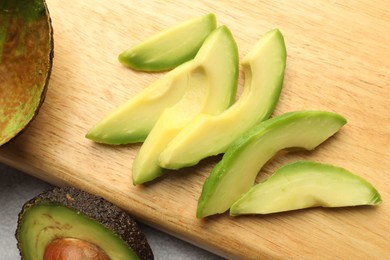 Photo of Cut ripe green avocado on table, top view