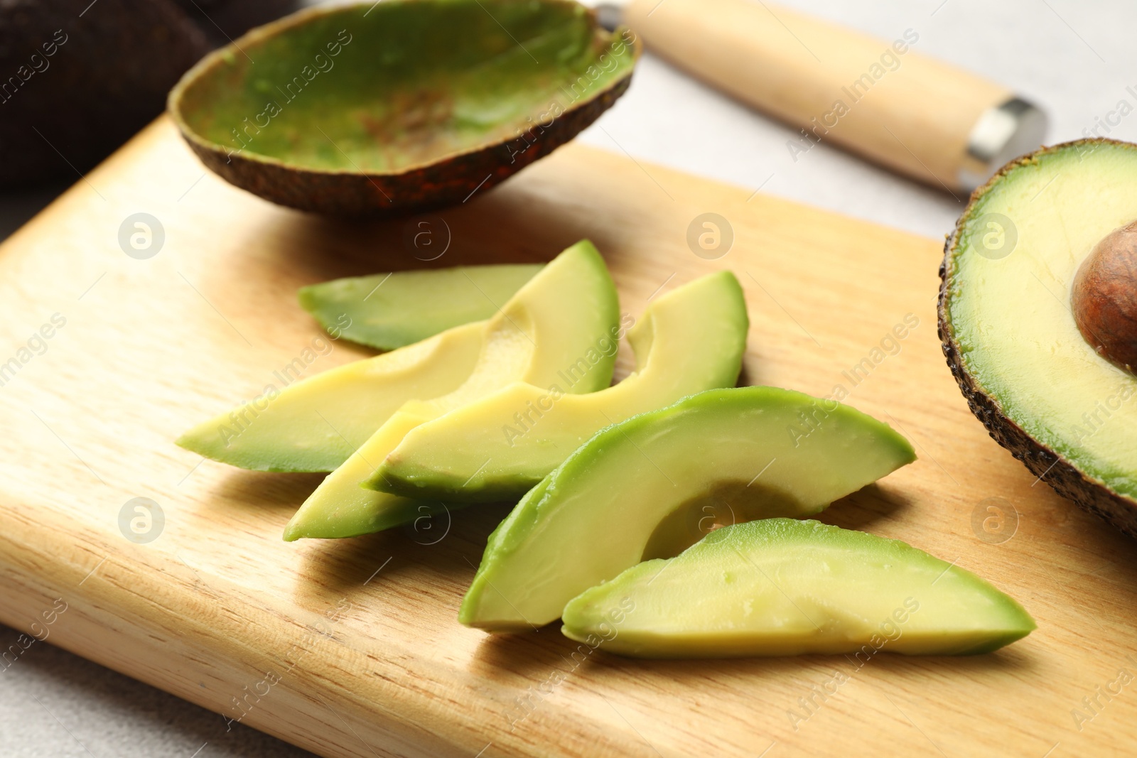 Cut ripe green avocado on table, closeup Photo of Cut ripe green avocado on table, closeup