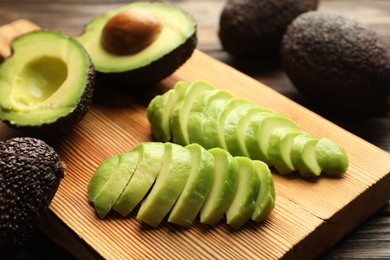 Photo of Fresh ripe green avocados on table, closeup