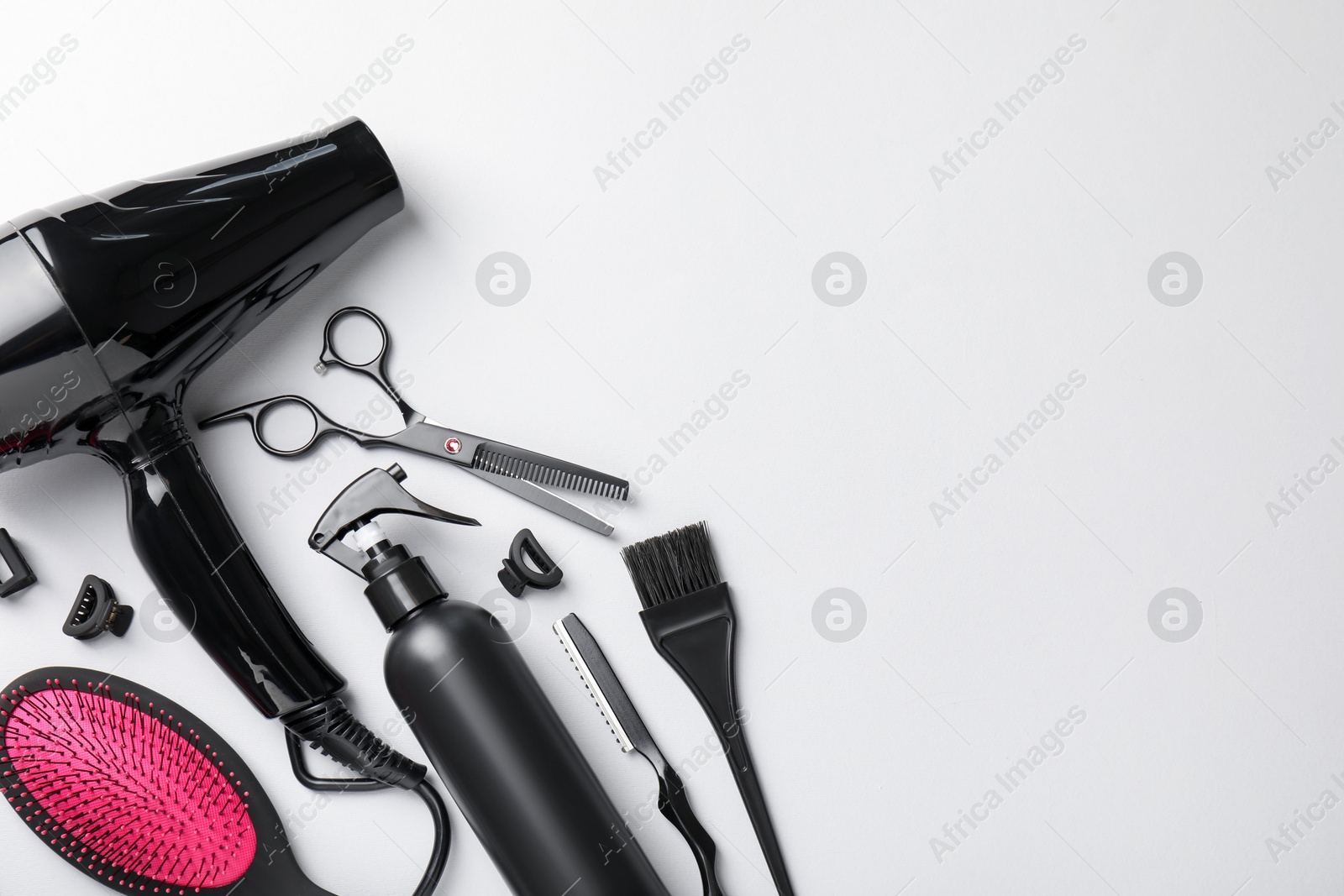 Different hairdresser's tools on light grey background, flat lay. Space for text Photo of Different hairdresser's tools on light grey background, flat lay. Space for text