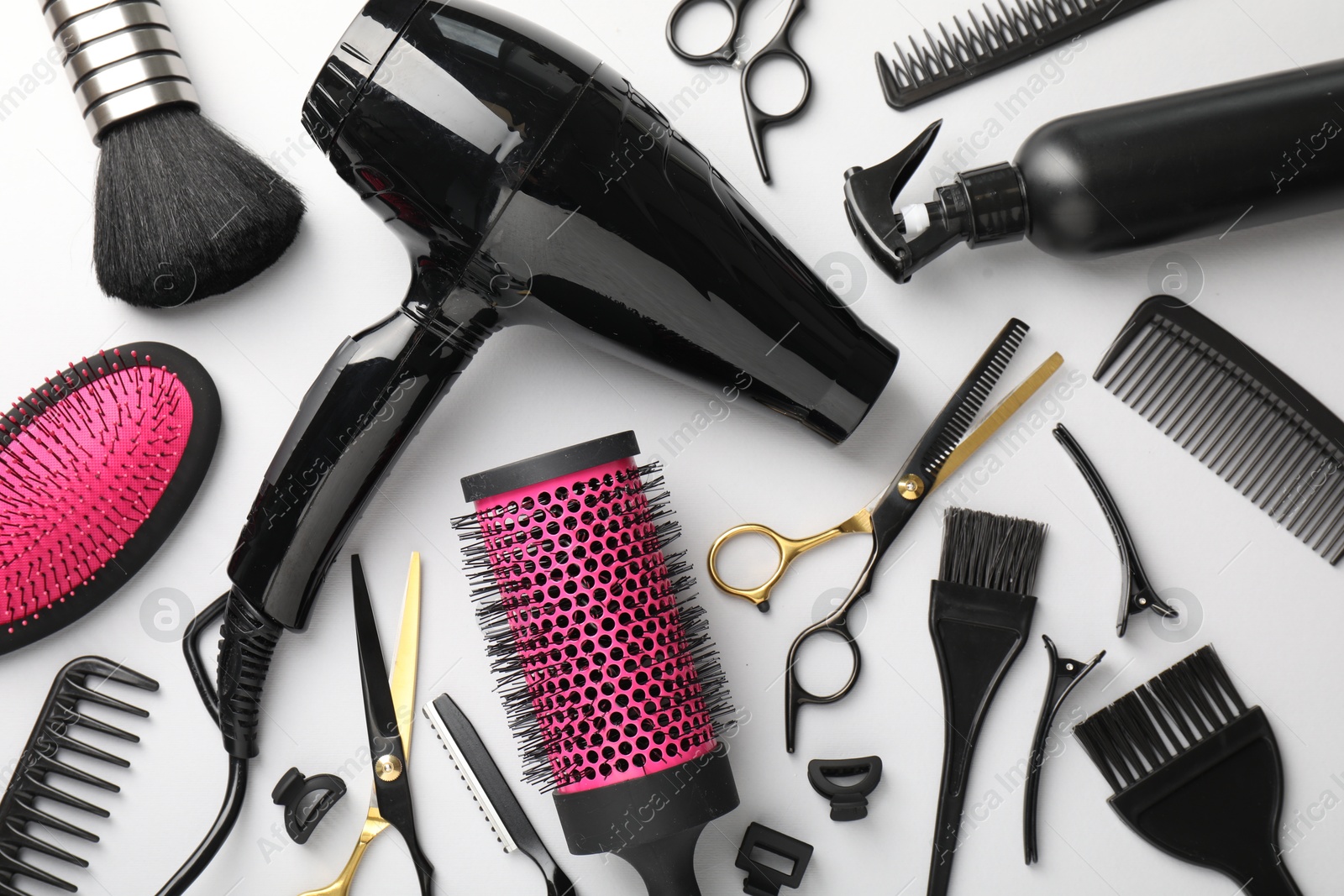 Different hairdresser's tools on light grey background, flat lay Photo of Different hairdresser's tools on light grey background, flat lay