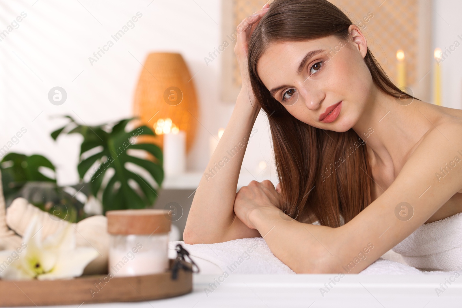 Beautiful woman relaxing on massage couch in spa salon, selective focus Photo of Beautiful woman relaxing on massage couch in spa salon, selective focus