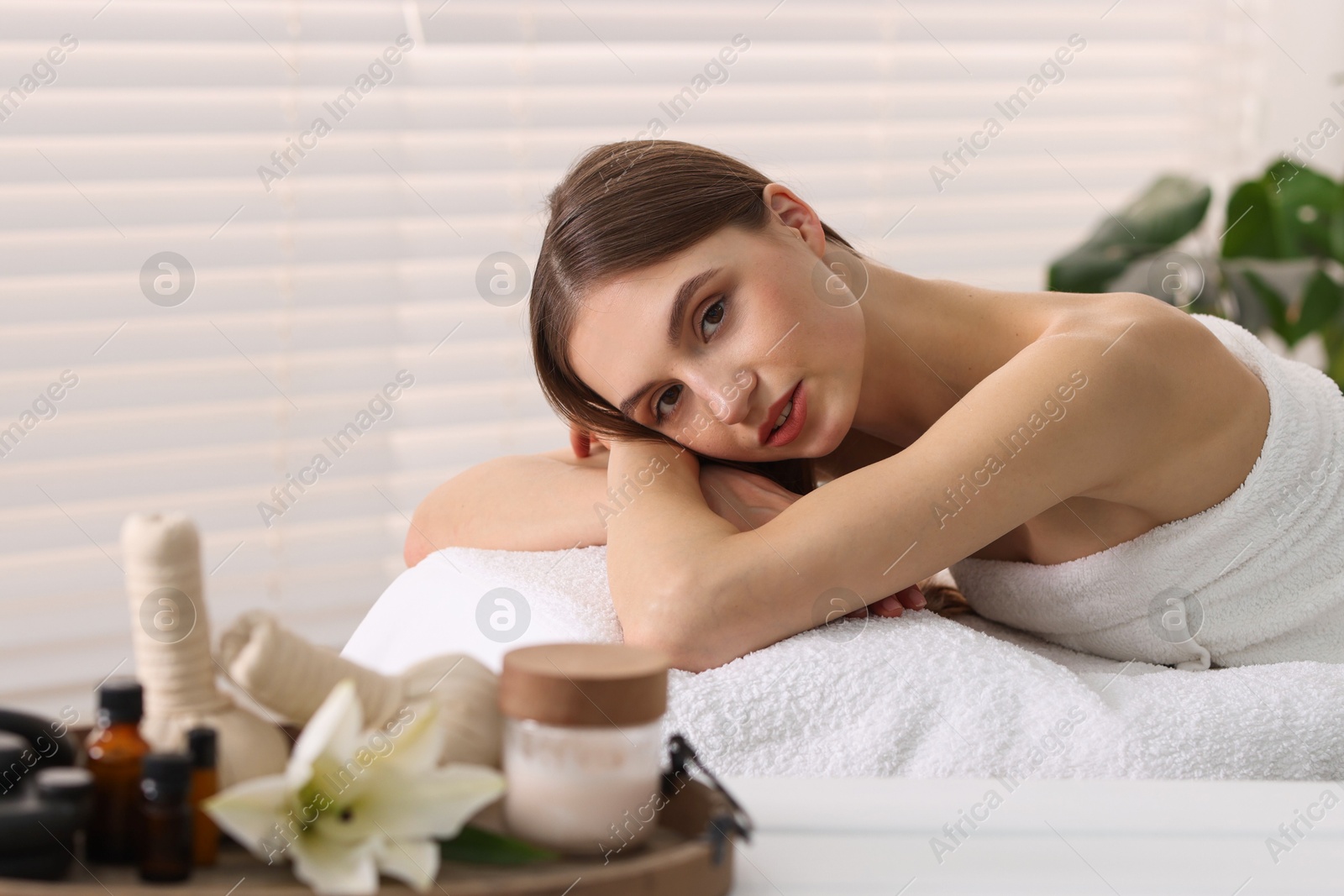 Beautiful woman relaxing on massage couch in spa salon, selective focus Photo of Beautiful woman relaxing on massage couch in spa salon, selective focus