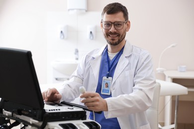 Photo of Professional sonographer with ultrasound machine in clinic