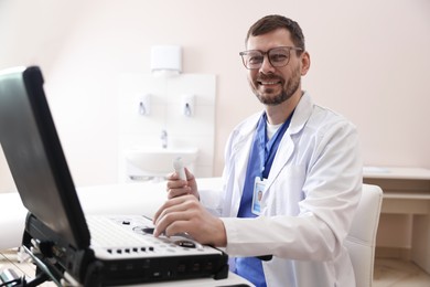 Photo of Professional sonographer with ultrasound machine in clinic