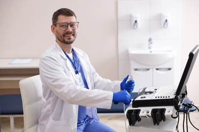 Photo of Professional sonographer with ultrasound machine in clinic