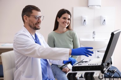 Photo of Sonographer showing woman her ultrasound imaging on screen in clinic
