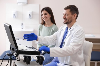 Photo of Sonographer showing woman her ultrasound imaging on screen in clinic