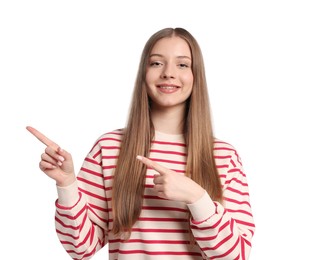 Photo of Teenage girl pointing at something on white background