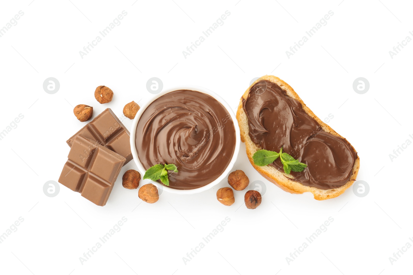Photo of Tasty chocolate spread with mint in bowl, toast and hazelnuts isolated on white, top view