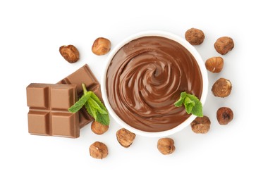 Photo of Tasty chocolate spread with mint in bowl and hazelnuts isolated on white, top view