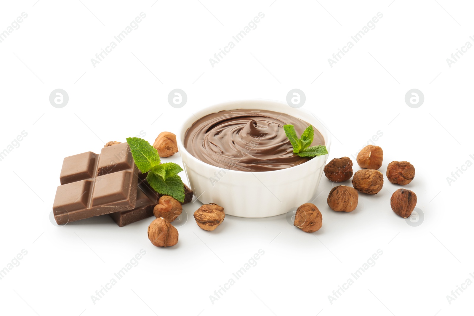 Photo of Tasty chocolate spread with mint in bowl and hazelnuts isolated on white