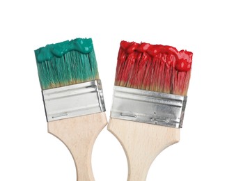 Photo of Brushes with green and red paints isolated on white