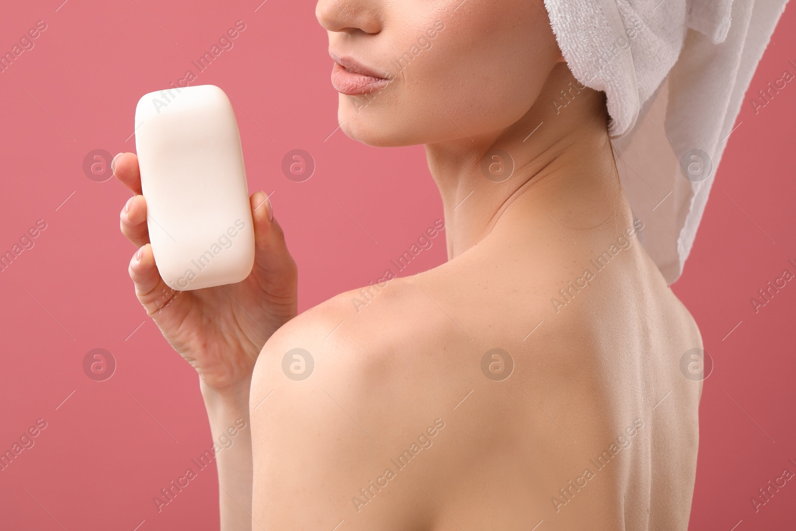 Woman with soap bar on pink background, closeup Photo of Woman with soap bar on pink background, closeup