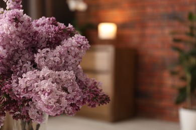 Photo of Beautiful lilac flowers at home, closeup. Space for text