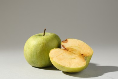 Photo of Damaged green apples on light grey background